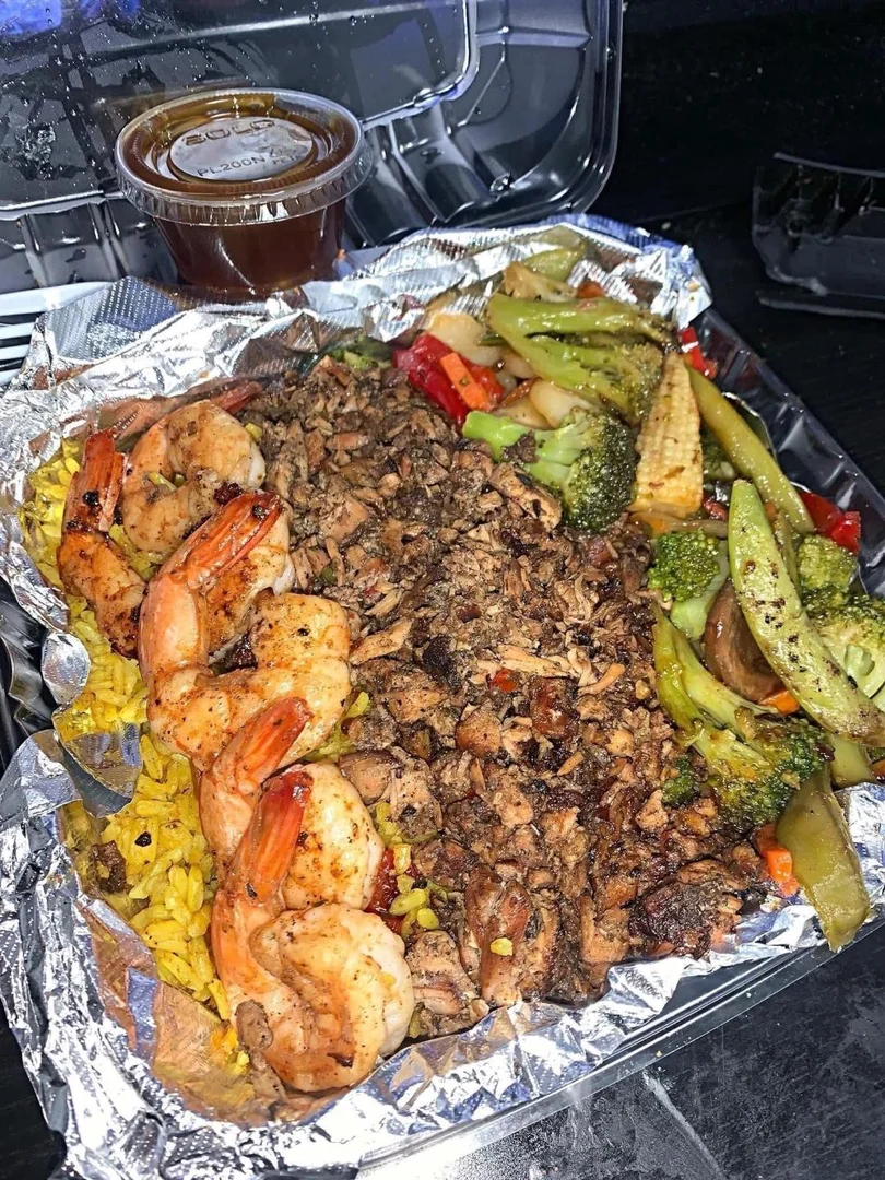 Jerk chicken and shrimp rice bowl with sautéed veggies