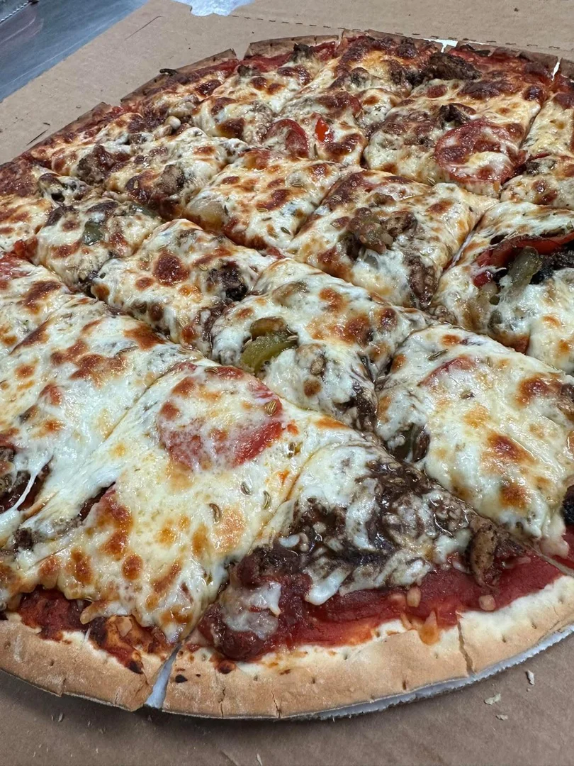 Fresh hand-made pizza loaded with cheese, sausage and peppers